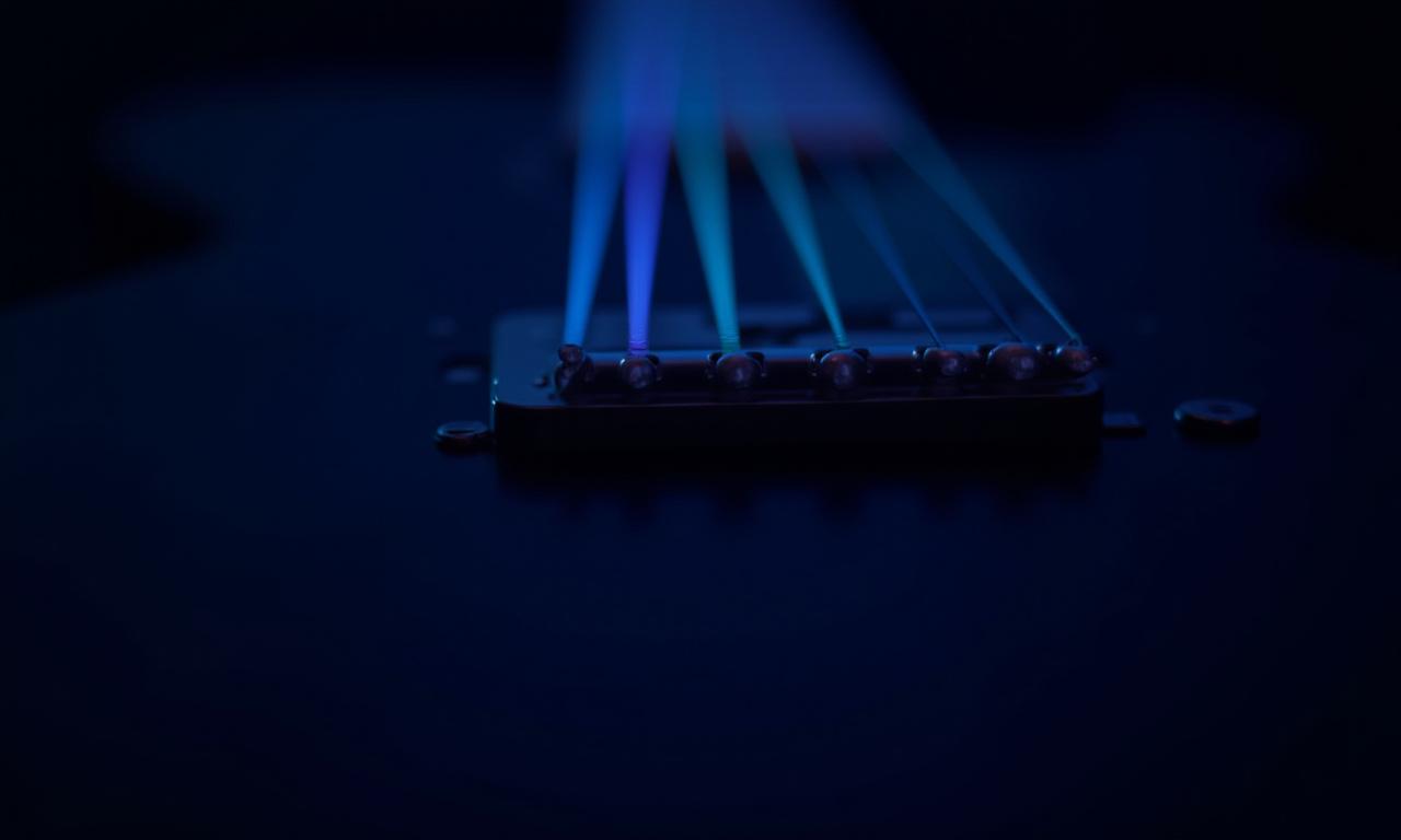 Close up of guitar strings with neon lighting