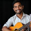 Vijayaraja Karangelen playing guitar